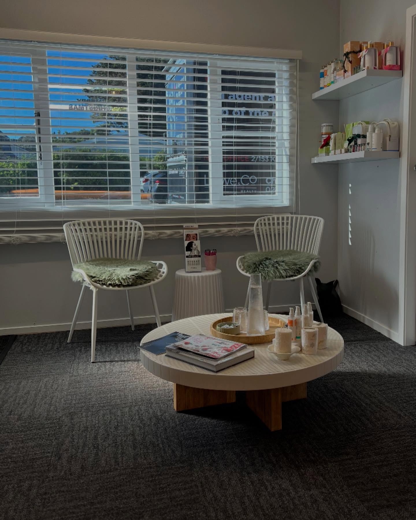 Modern beauty clinic waiting area with white chairs