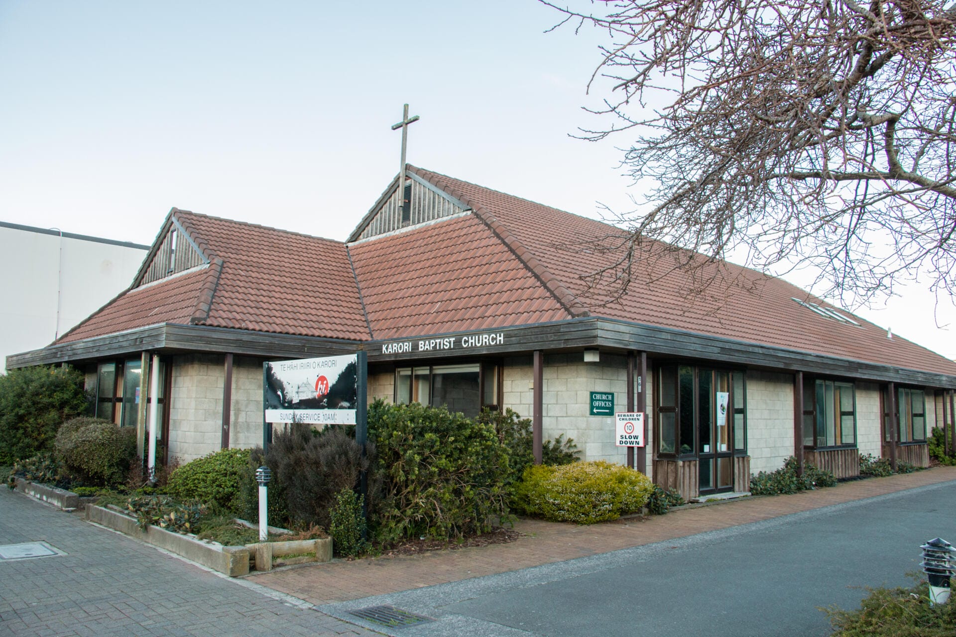 Karori Baptist Church exterior with cross and signage