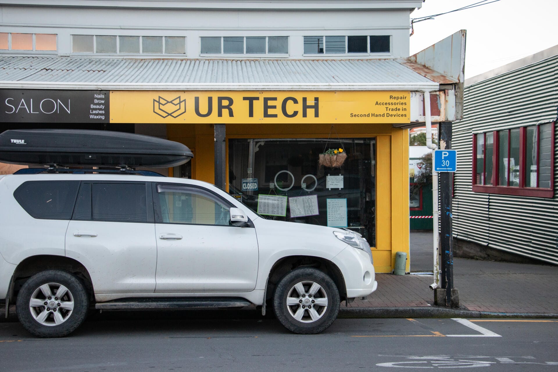White SUV parked outside UR Tech shop