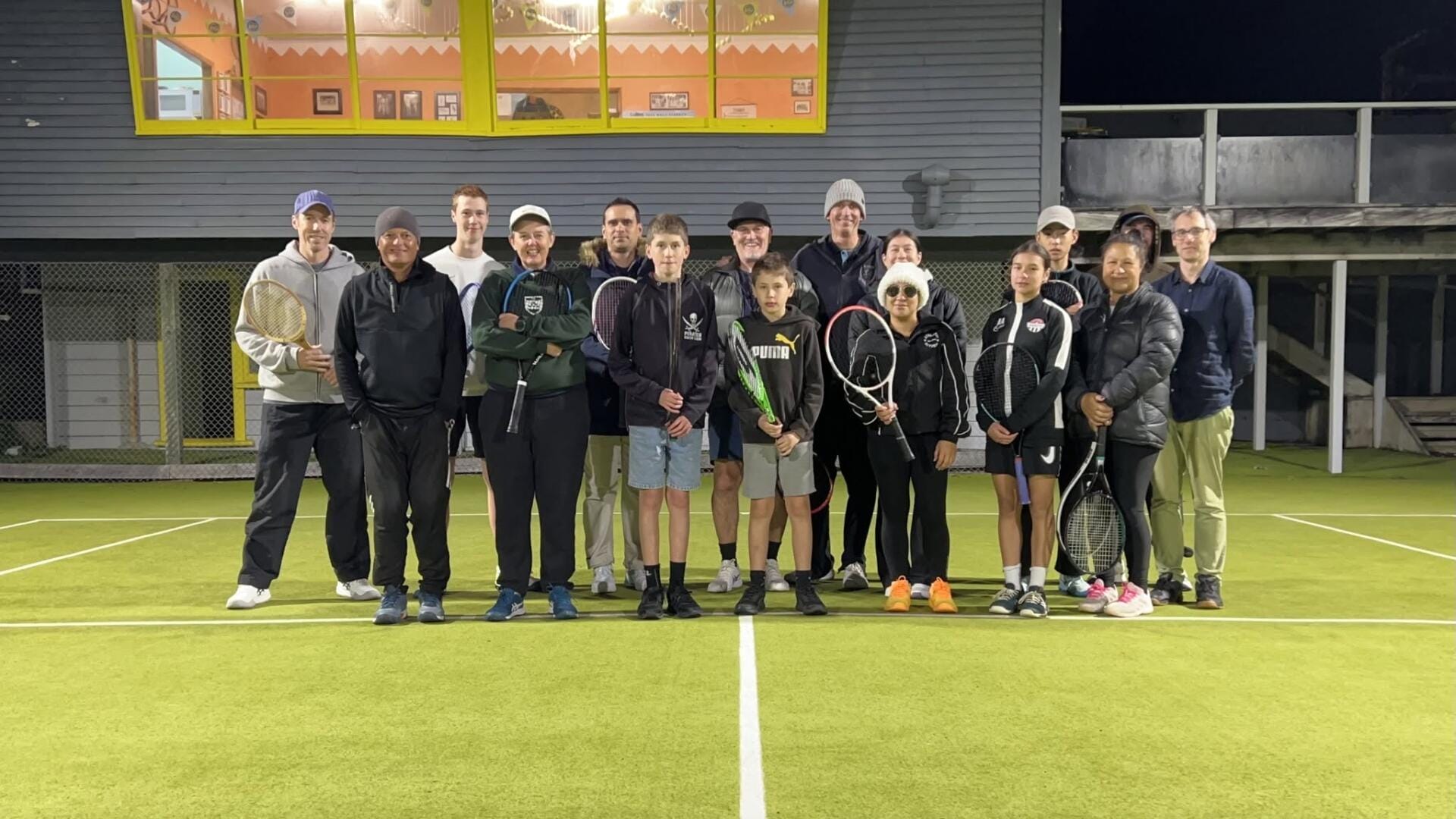 Group of tennis players on night court