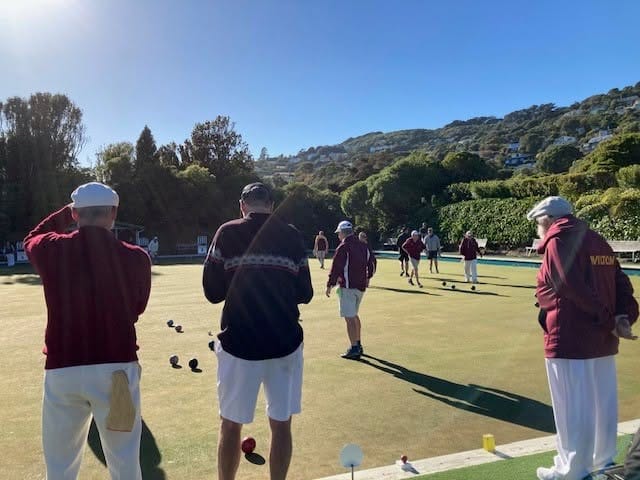 Men playing lawn bowls on sunny green