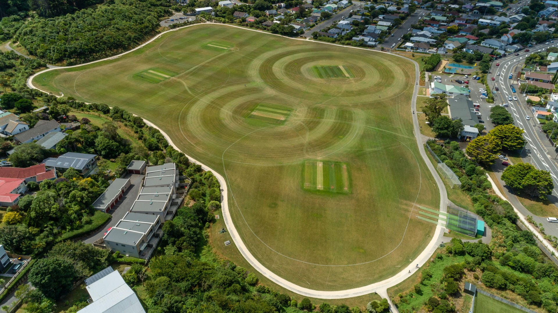 Aerial view of suburban cricket ground and houses